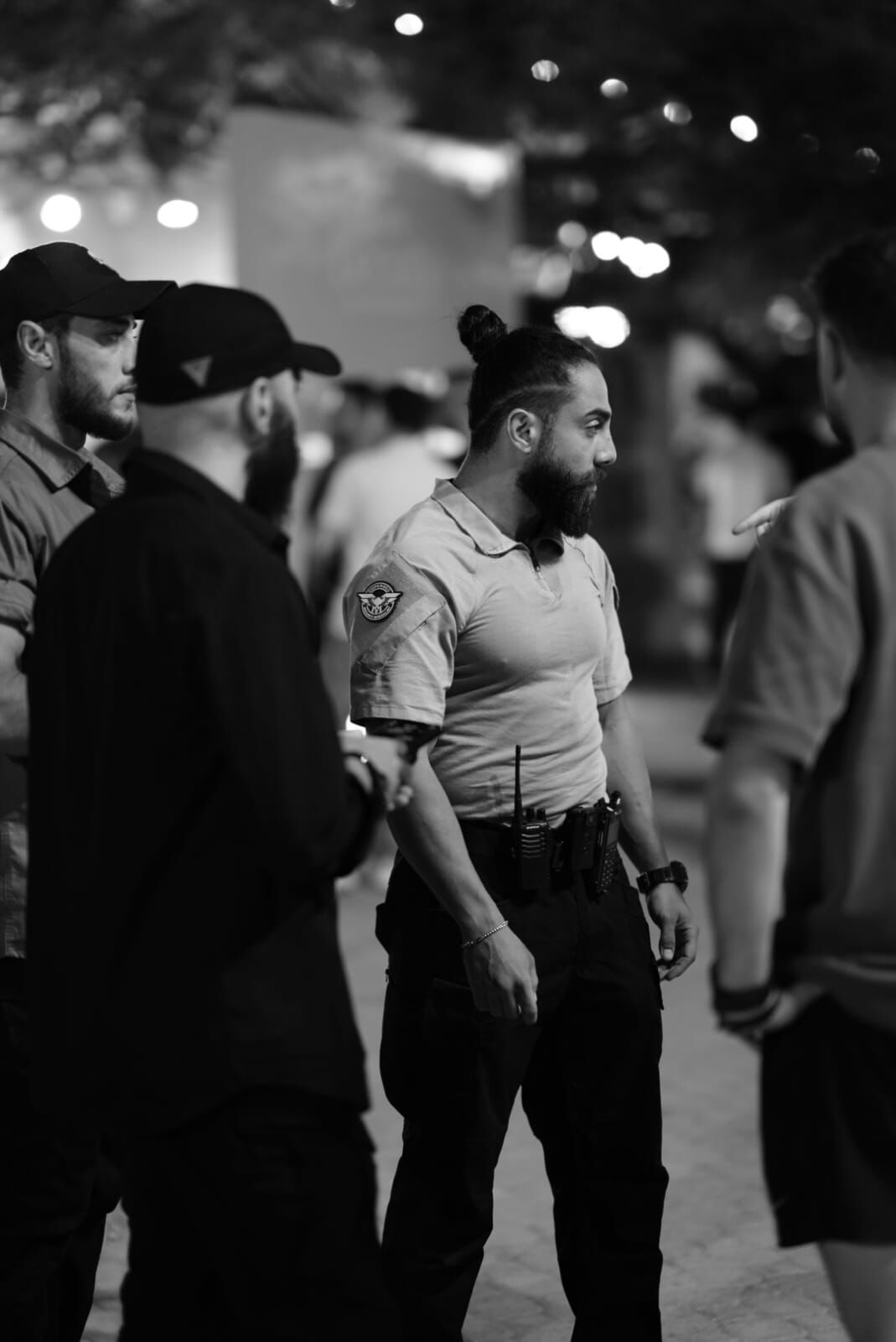 Low-profile COPERSEC agents watching a crowd at night